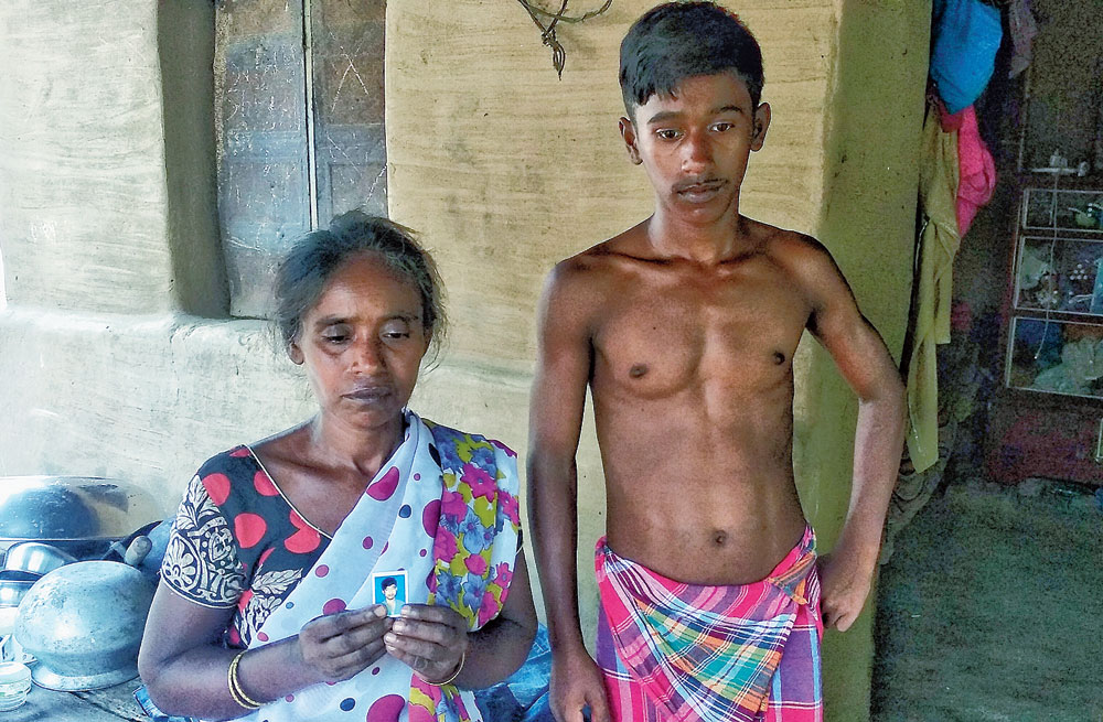 Swarna Das shows a picture of her elder son Shibu
