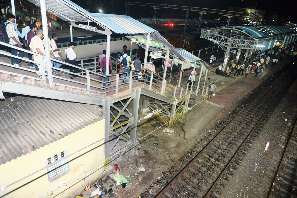 Shoes, bags and other items lie under the footbridge at Santragachi station where a stampede claimed the lives of two passengers