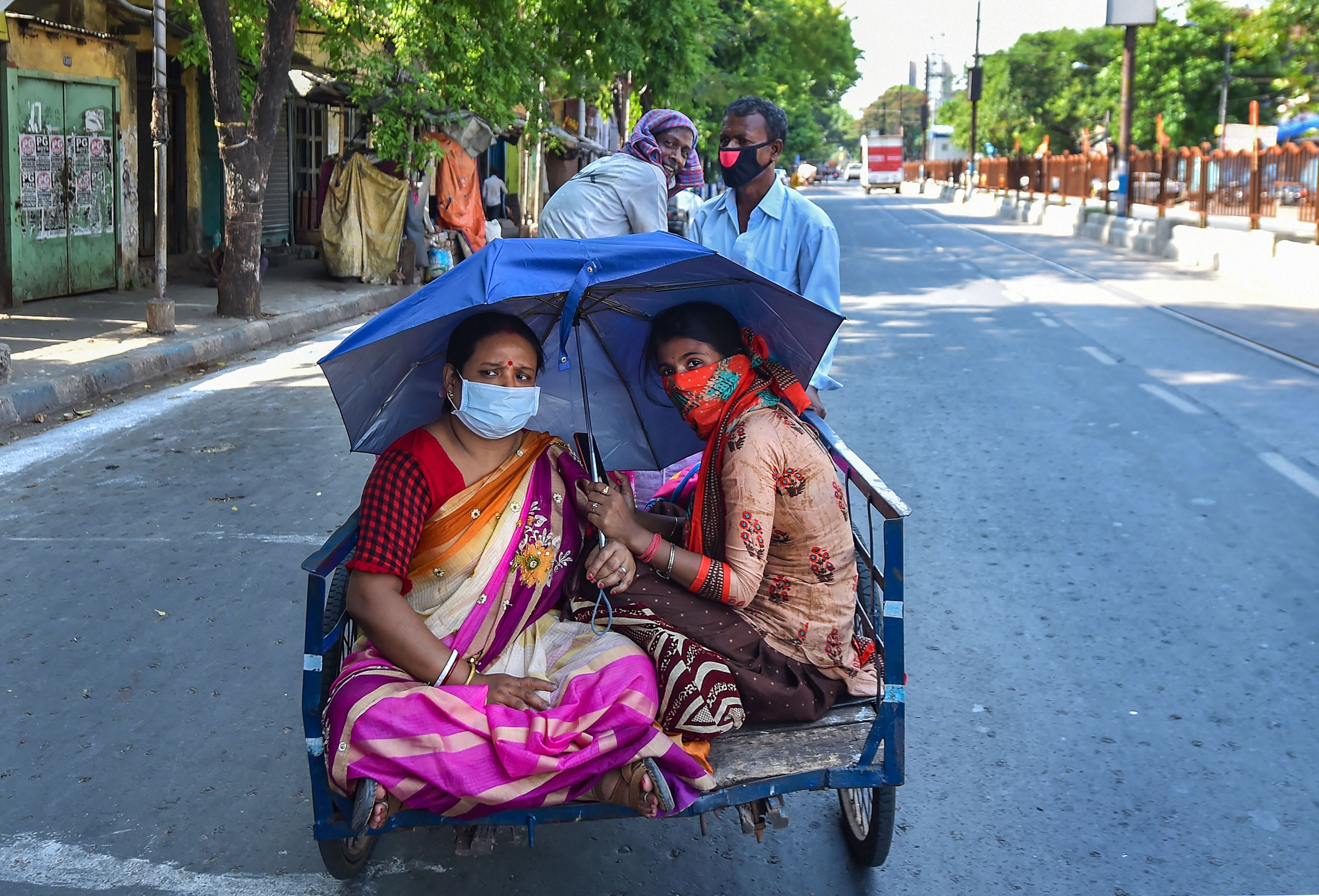 A worker pulls a cart with passengers, during the fourth phase of the ongoing Covid-19 nationwide lockdown, in Kolkata, Monday, May 18, 2020.
