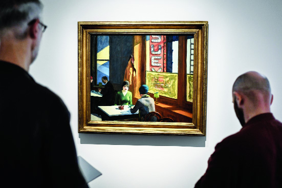 Visitors admire Edward Hopper’s painting Chop Suey at the Christie’s auction house in Paris.