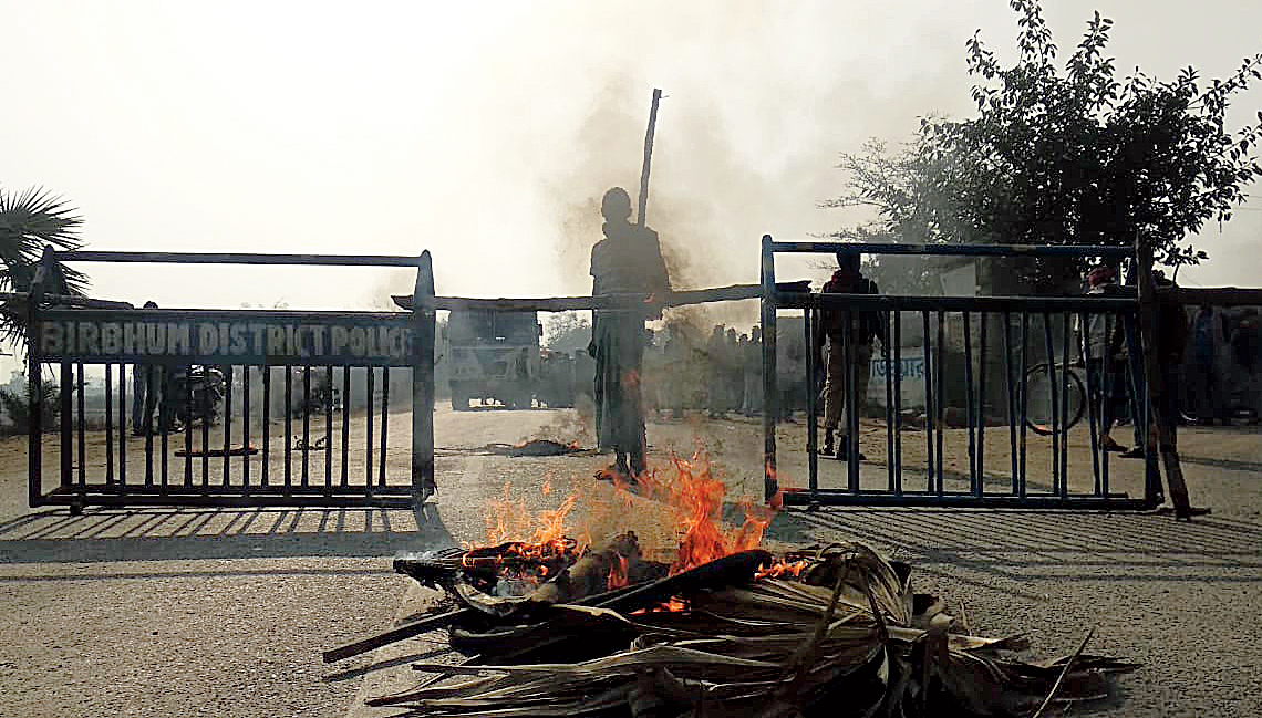 A fire set by protesters near a roadblock. 
