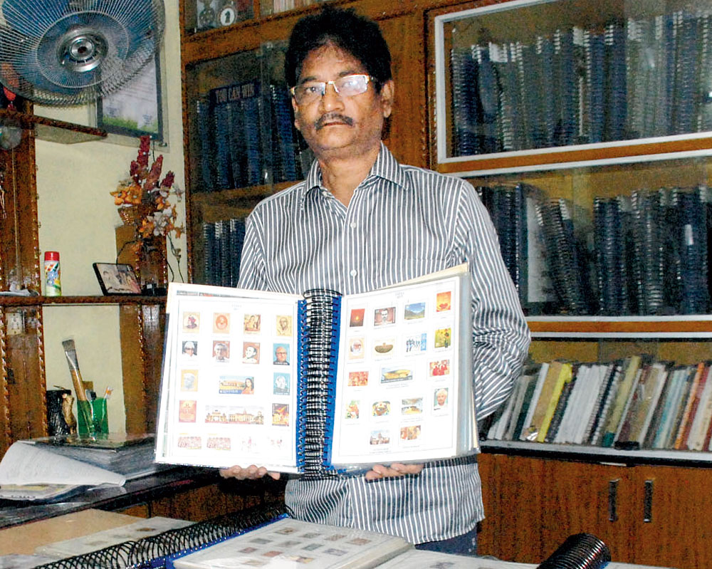 Amrendra Anand shows his collection of postal stamps and envelopes at his home in Dhanbad on Tuesday 
