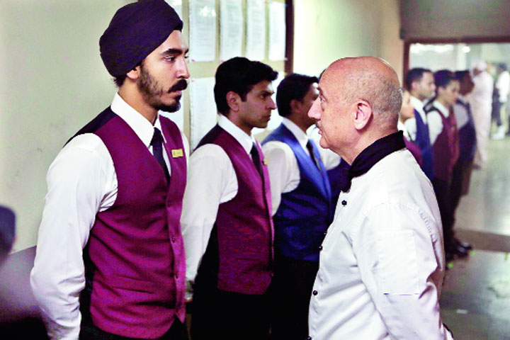 Dev Patel and Anupam Kher in a scene from the film