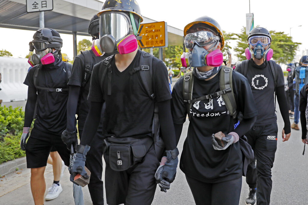 Protesters carry bricks during a demonstration near Central Government Complex in Hong Kong on Sunday, September 15, 2019, as violence flared anew after thousands of pro-democracy supporters marched through downtown in defiance of a police ban