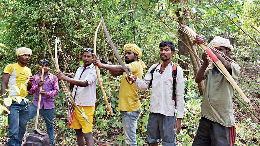 Tribals with traditional weapons head for the hunting festival last year