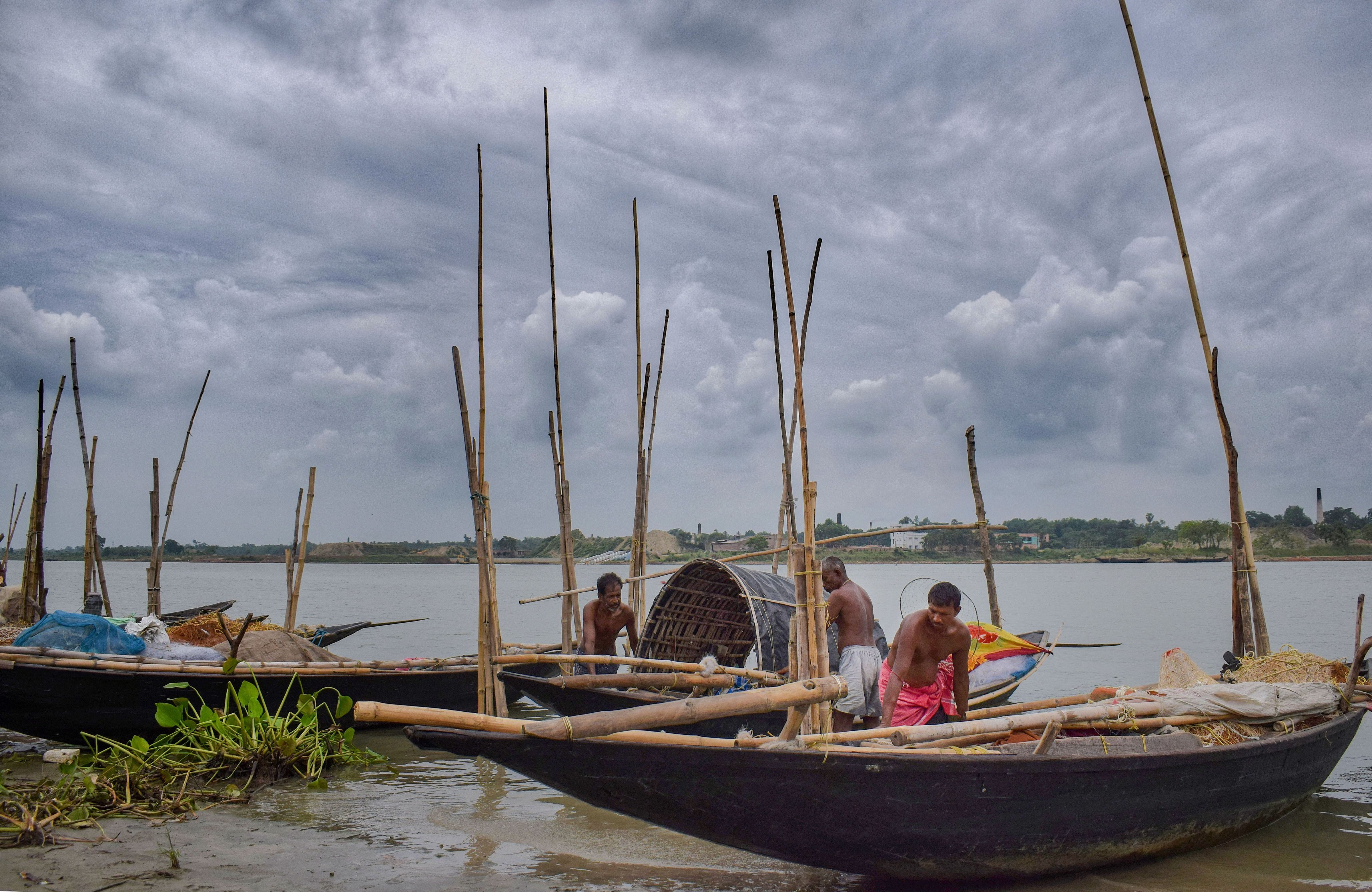 Fishermen anchor their boats along the banks of river Hooghly, ahead of the landfall of Cyclone Amphan, at Santipur, Nadia, Tuesday.