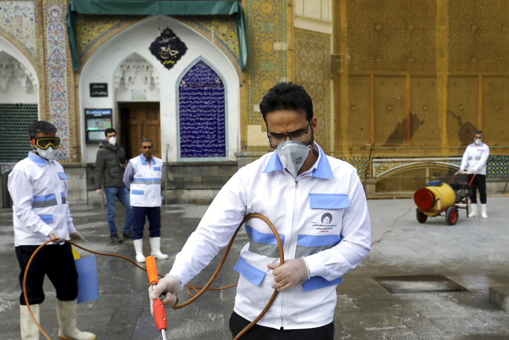 Workers disinfect the shrine of the Shiite Saint Imam Abdulazim to help prevent the spread of the new coronavirus in Shahr-e-Ray, south of Tehran, Iran, Saturday, March, 7, 2020.