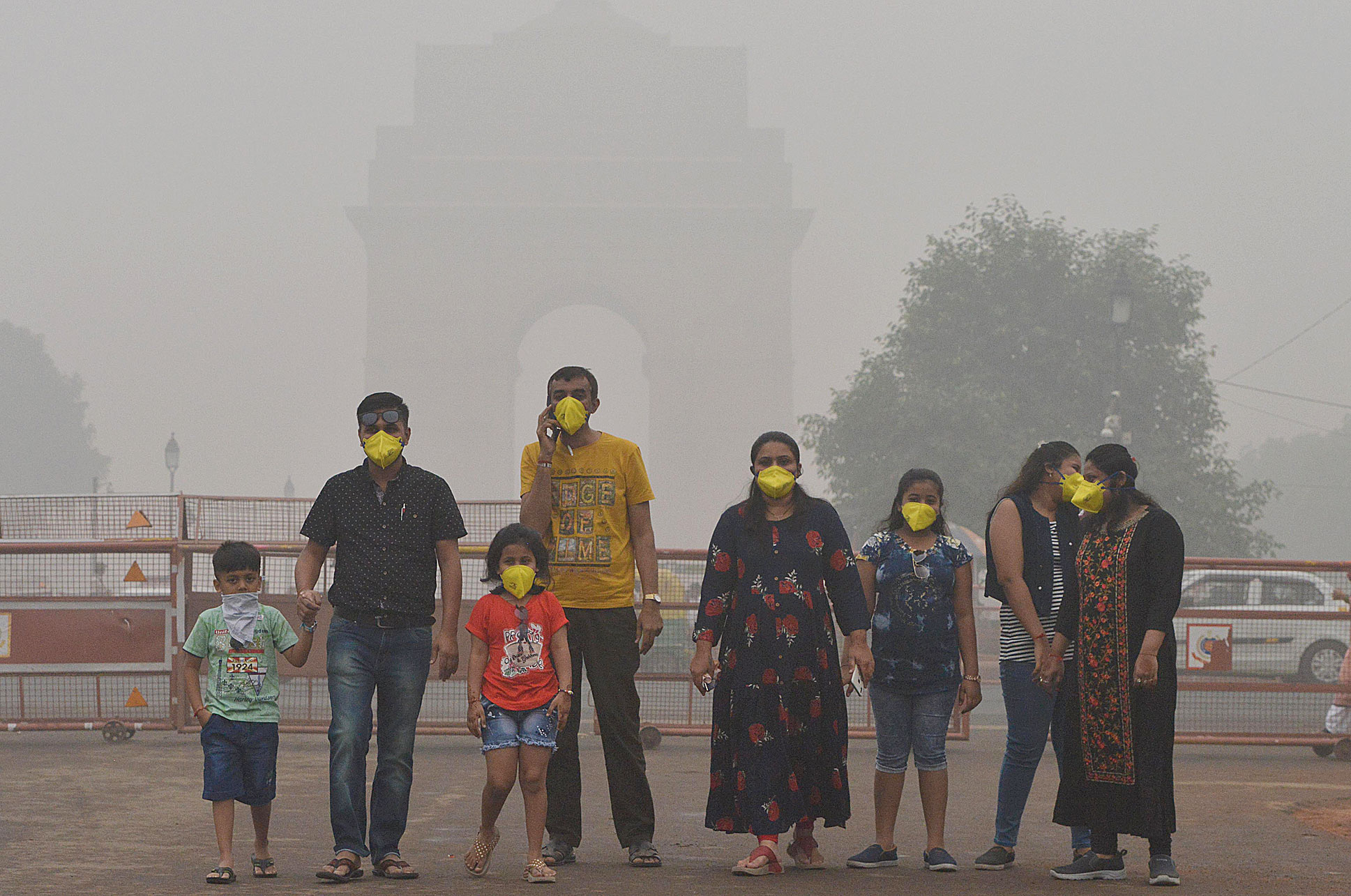 People wearing masks to protect themselves from pollution at India Gate on Sunday. 