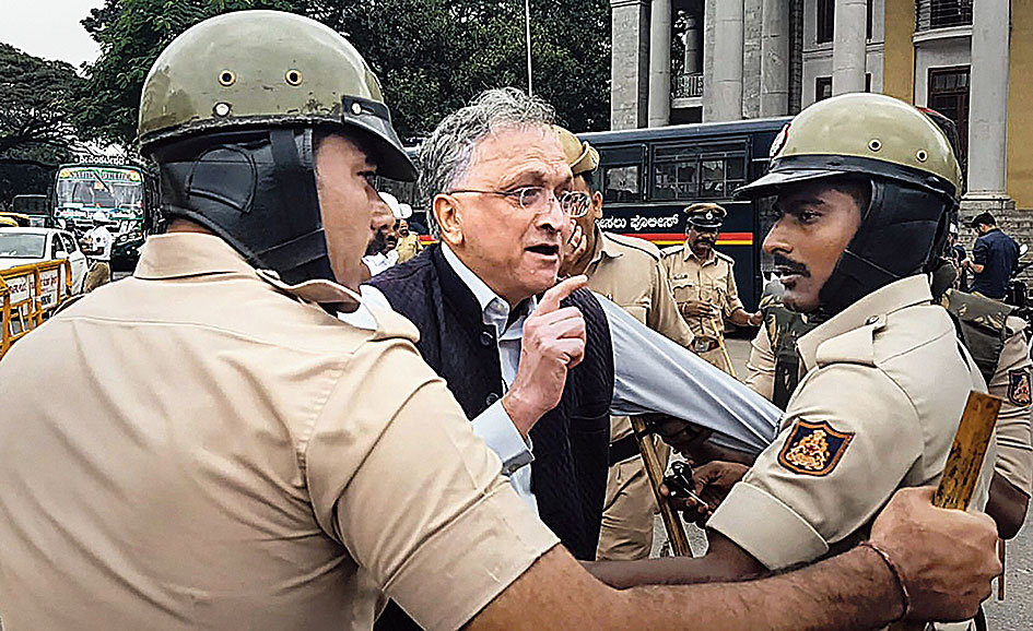 Ramachandra Guha being detained by police at Town Hall in Bangalore on Thursday. (PTI)