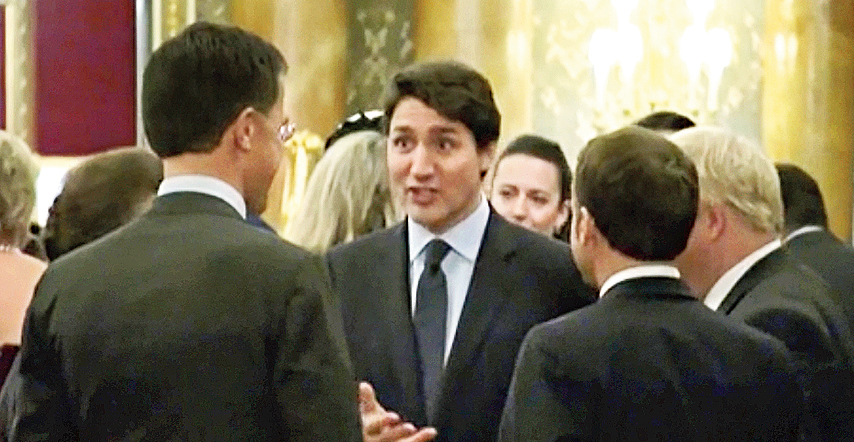 A picture taken from a video shows Canadian Prime Minister (centre) speaking with other world leaders at a reception in Buckingham Palace. 
