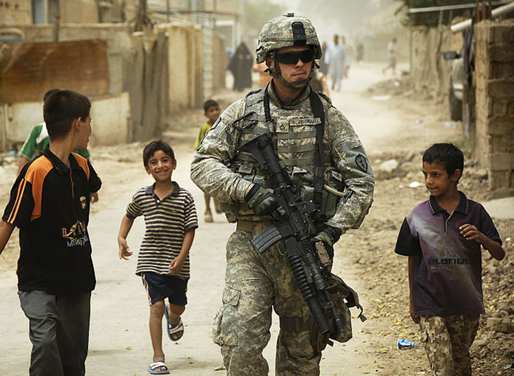 Iraqi children gather around a US soldier in Al Asiriyah, Iraq, in 2008. What breaks down the dubious narrative of the oppressor occupying the moral high ground, leading to the eventual failure of the occupation, is that violence perpetrated in the name of liberty is usually disproportionate