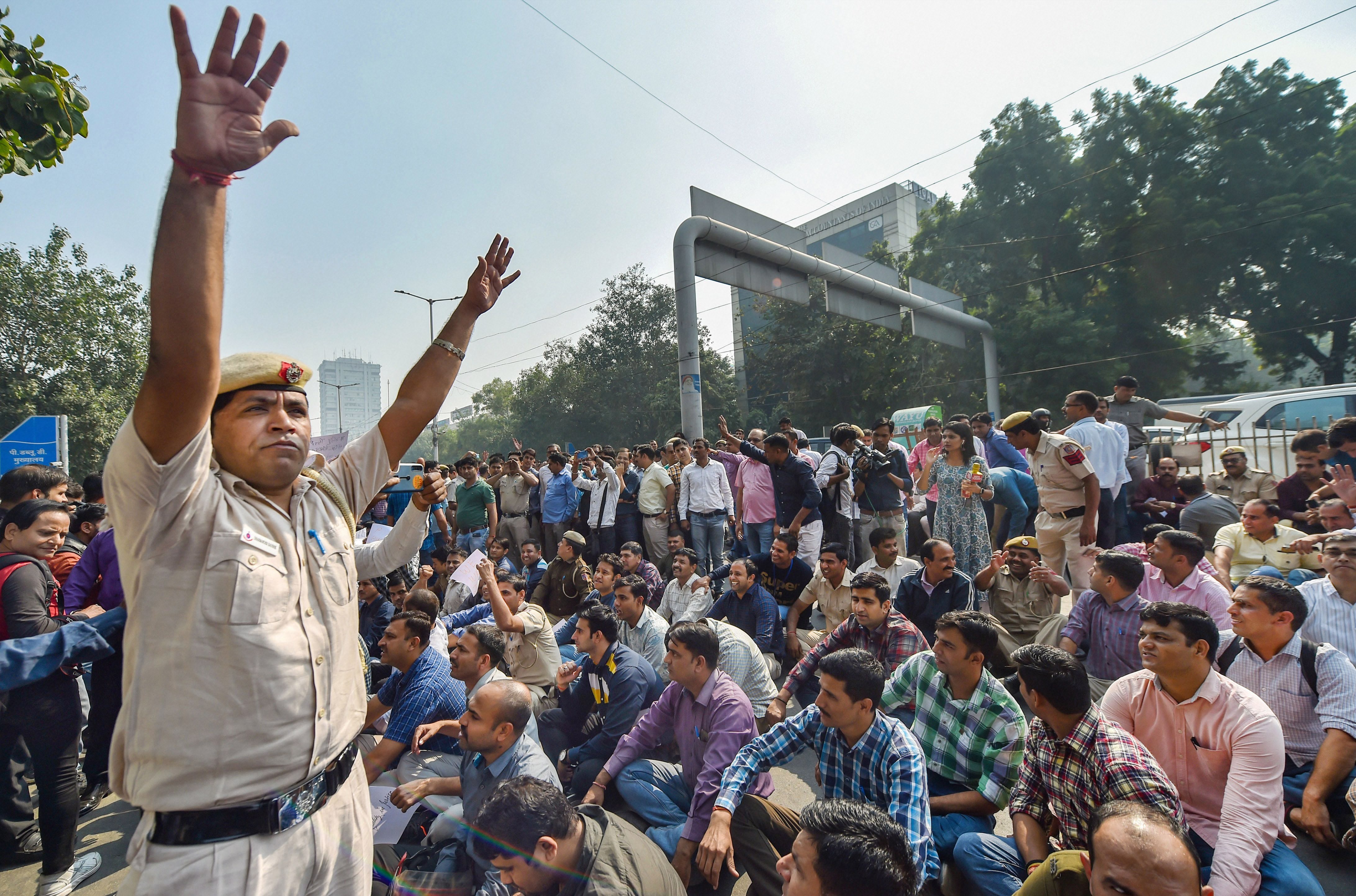 Police personnel gather outside the police headquarters in ITO to protest against the assault on policemen following clashes with lawyers at Tis Hazari court and alleged thrashing of a cop in Saket, in New Delhi, Tuesday, November 5, 2019. 