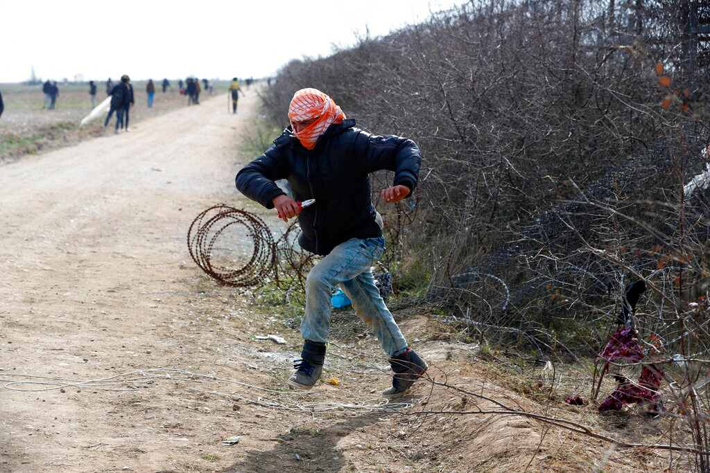 A migrant runs during clashes with Greek police in Edirne, Turkey, on March 2
