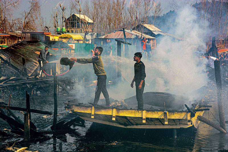 Locals attempt to douse a fire in houseboats at KoniKhan, Dal Lake in Srinagar, last month. Three houseboats were charred .