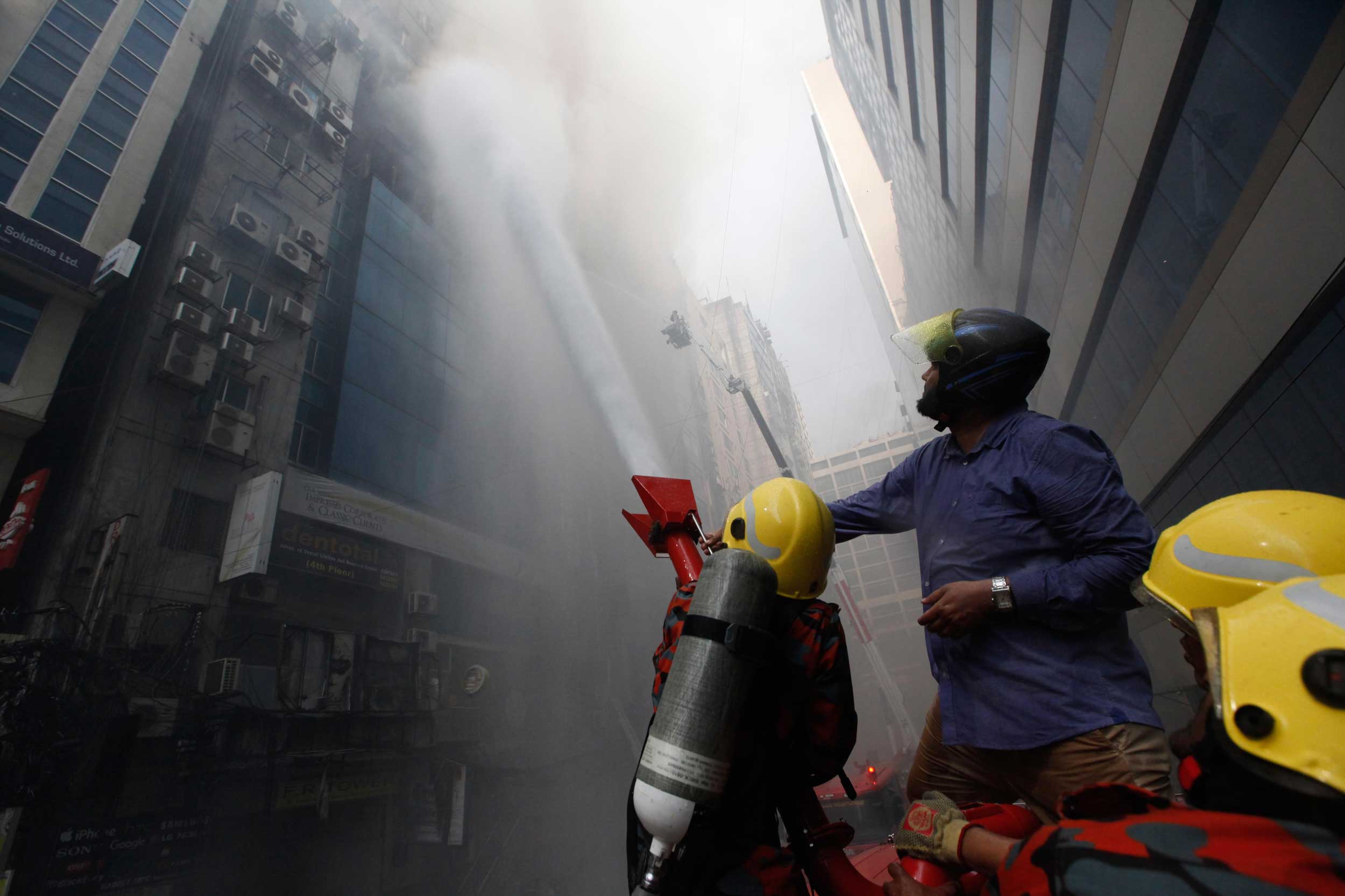 Firefighters trying to douse a fire in a multi-storied office building in Dhaka, Bangladesh, on Thursday.