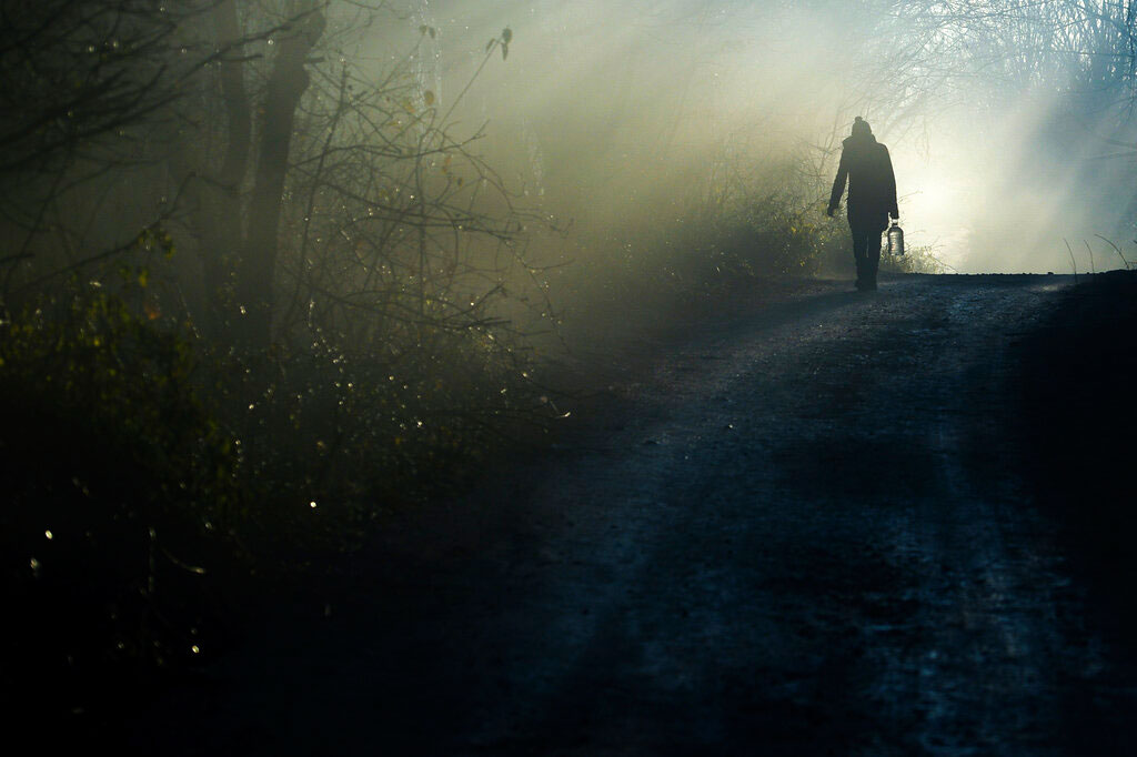 A migrant carries water to the Vucjak refugee camp outside Bihac, northwestern Bosnia, on Sunday. It has been reported that Bosnian officials will close the makeshift tent camp in northwestern Bosnia where hundreds of migrants remain stranded despite snow and freezing weather.