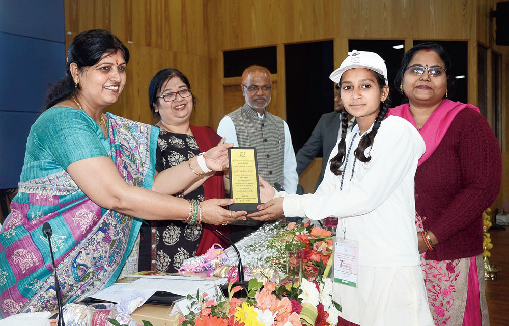 State education minister Neera Yadav felicitates Ankita Singh of Government KC Girls School, Jharia, for her multipurpose chullah, which won the coveted INSPIRE award earlier, in Ranchi on Tuesday. 