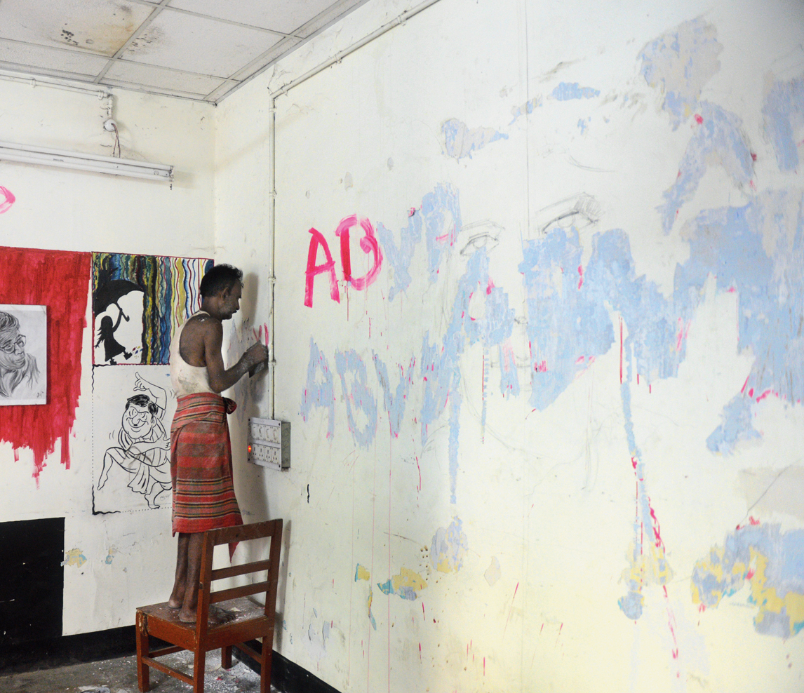 A painter whitewashes the vandalised walls of the students’ union room at JU on Friday. 
