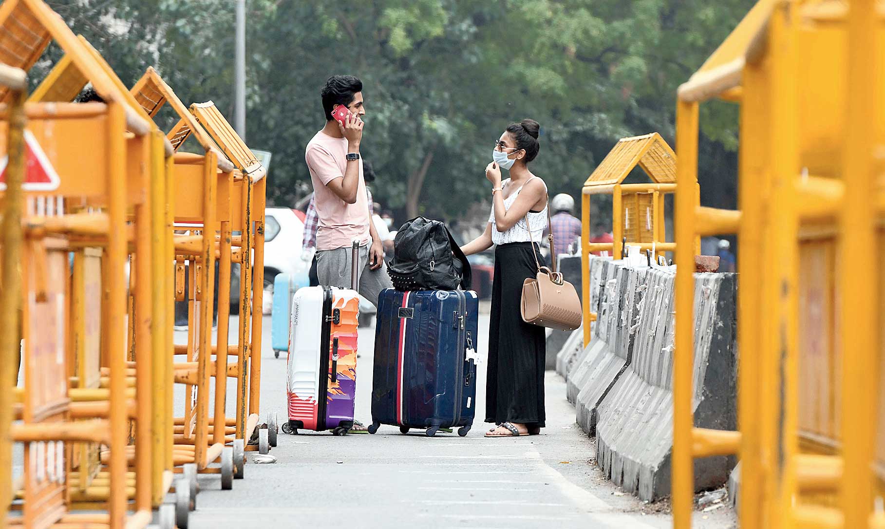 Passengers arrive at New Delhi Railway Station on Wednesday following the resumption of passenger train services 