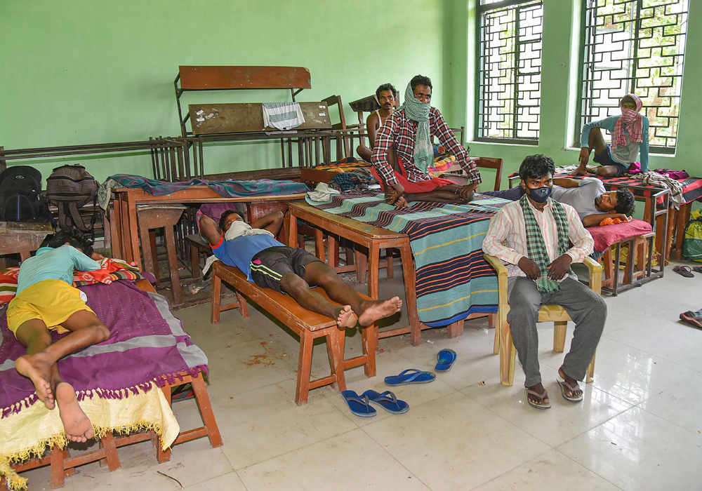 Migrant workers take refuge at a camp run by Bihar government during a complete lockdown imposed in the wake of coronavirus pandemic, in Patna, Saturday, April 18, 2020.