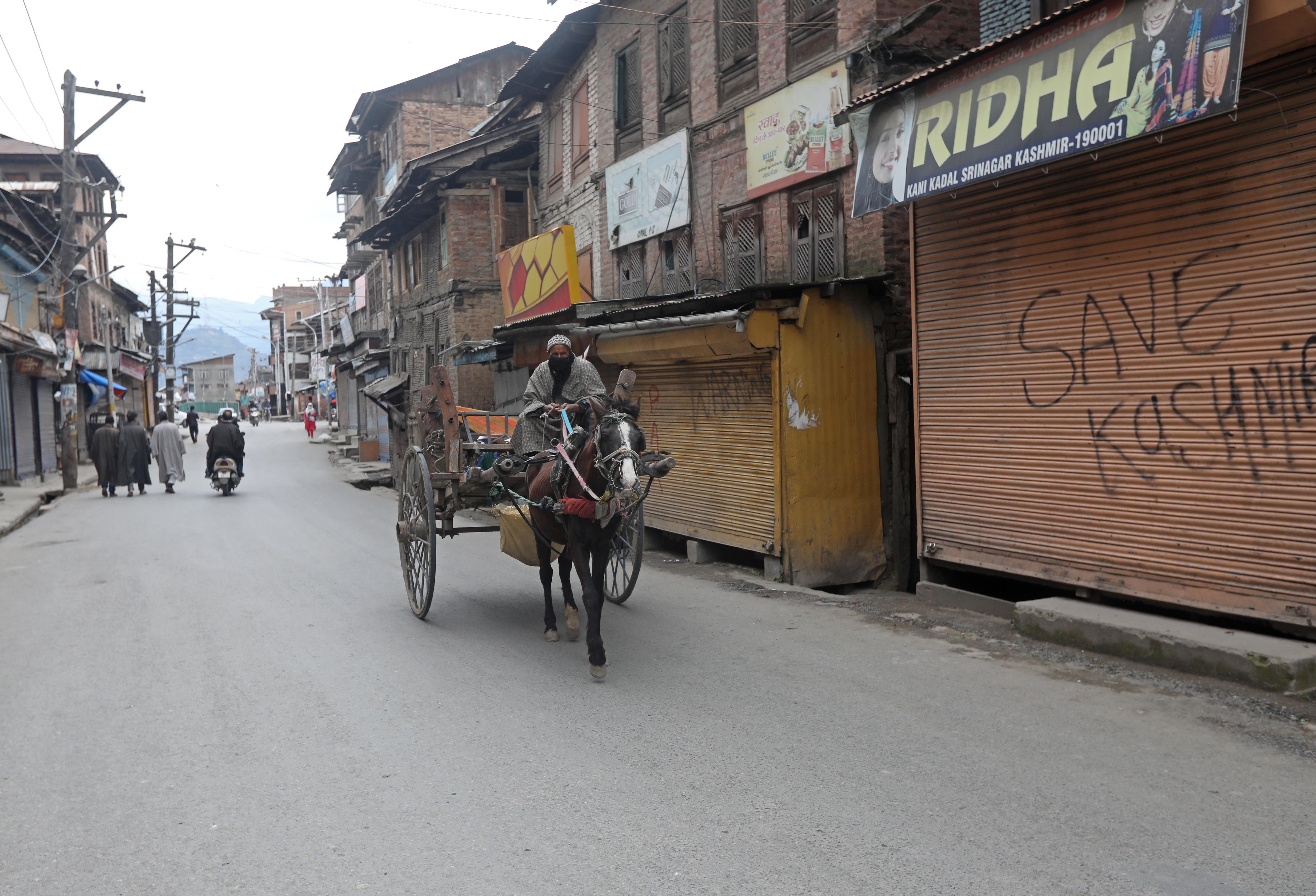 ESSENTIAL DELIVERY: A cart supplying milk in locked down area of Kani Kadal, Srinagar.