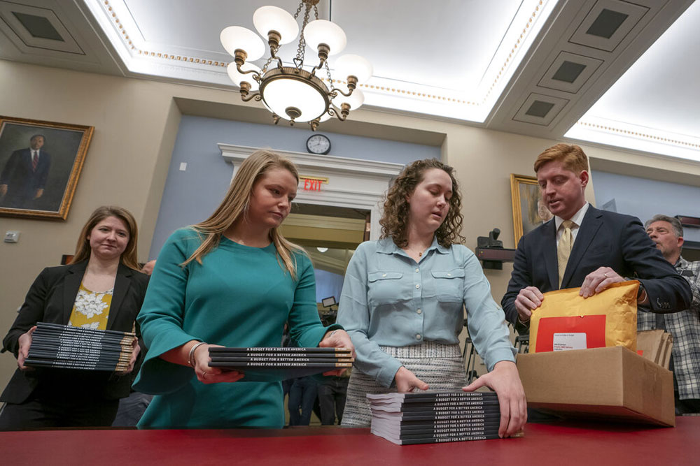 Office of Management and Budget staff delivers President Donald Trump's 2020 budget to the House Budget Committee on Capitol Hill in Washington, Monday, March 11, 2019. 