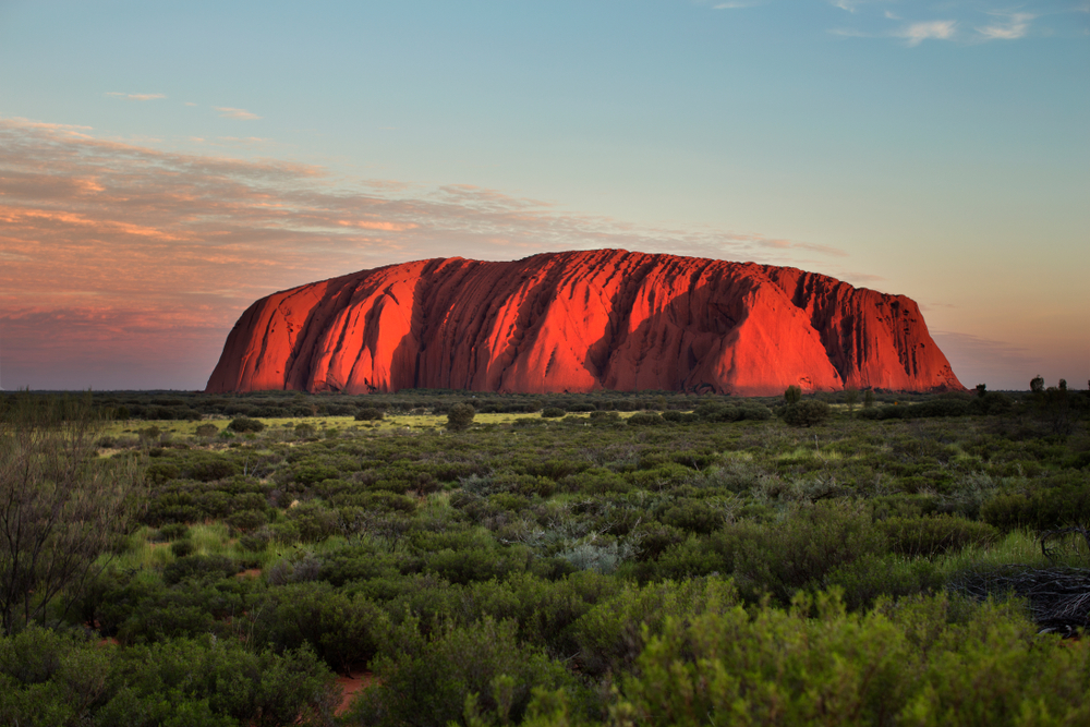 Many of the Anangu themselves live in a trash-strewn community near the rock that is closed to visitors, a jarring contrast to the exclusive resorts that surround the monolith, where tourists seated at white tablecloths drink sparkling wines and eat canapés as the setting sun turns Uluru a vivid red