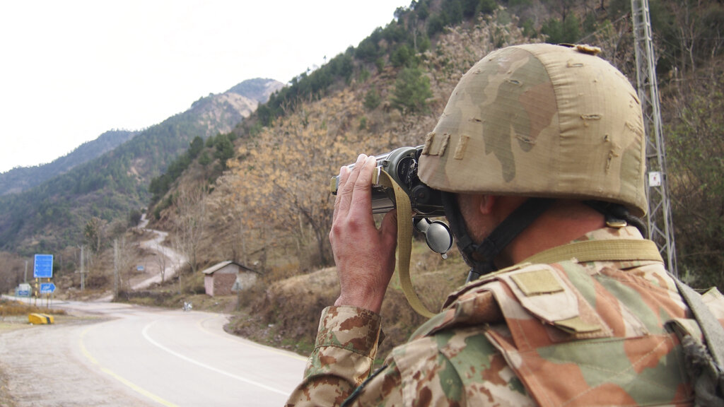 A Pakistani soldier watches the movement of Indian forces along the Line of Control from a Chakoti post, 50 km from Muzaffarabad, the capital of Pakistan-occupied Kashmir. 