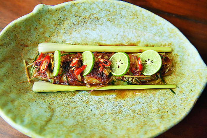 Steamed Fish in Thai Herbs is a dish where your choice of fish — basa or bekti — is steamed with lemongrass and Thai herbs. The soft fish is garnished with lemongrass, Kaffir lime leaves and lots of chillies. The fish is delicate and melts in your mouth leaving you wanting more.