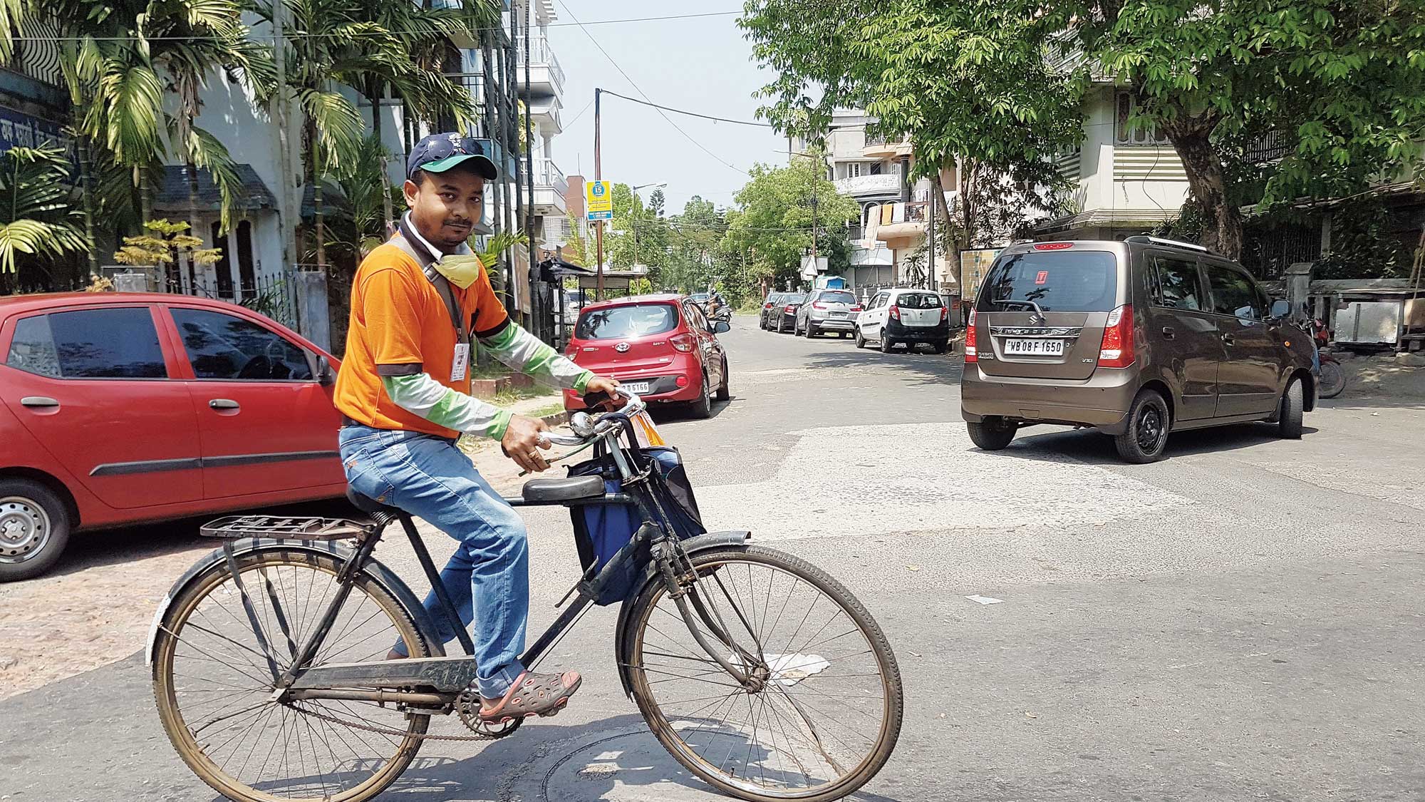 Mithun Adhikary cycles to deliver food to a home on behalf of the app Swiggy