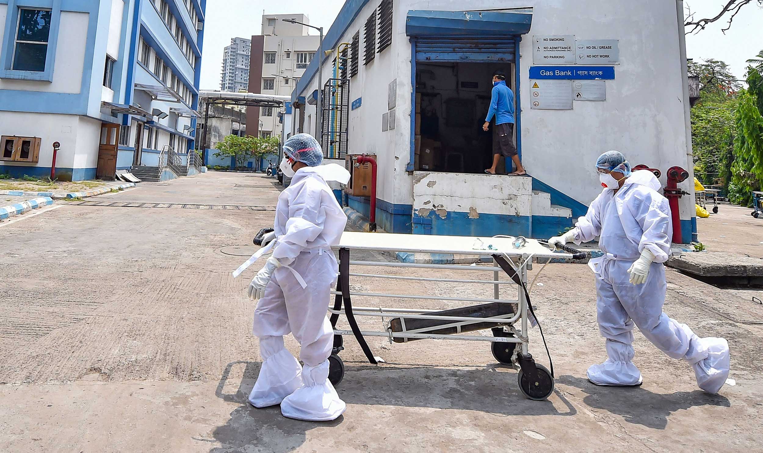 Medical workers wearing protective suits carry a stretcher for a Covid-19 patient at a Calcutta hospital on Monday.
