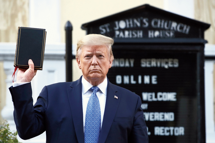 President Donald Trump holds a Bible during a visit to St John’s Church near the White House. 
