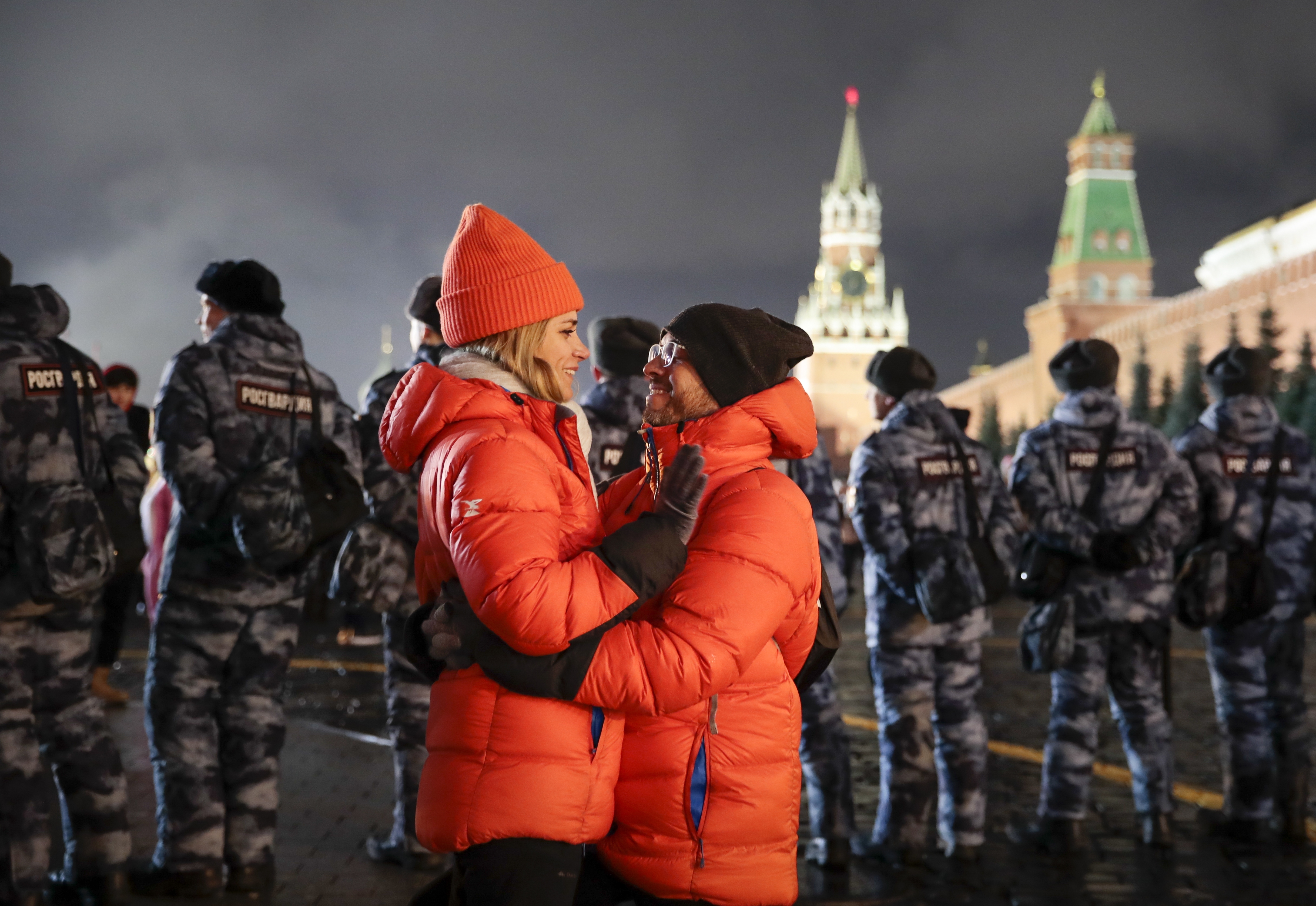 A couple share a tender moment during New Year's celebrations in Red Square with the Spasskaya Tower, second right, in the background in Moscow, Russia, on January 1, 2020