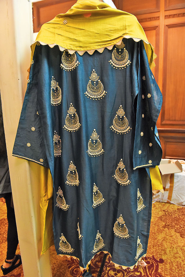 This midnight blue salwar set with pearl work and cutdana detailing has jhumka motifs for that extra dash of festivity. The lime dupatta with a scalloped border is a perfect contrast! Rs 14,500 @Vaga Fashions (contact: 97176533307)