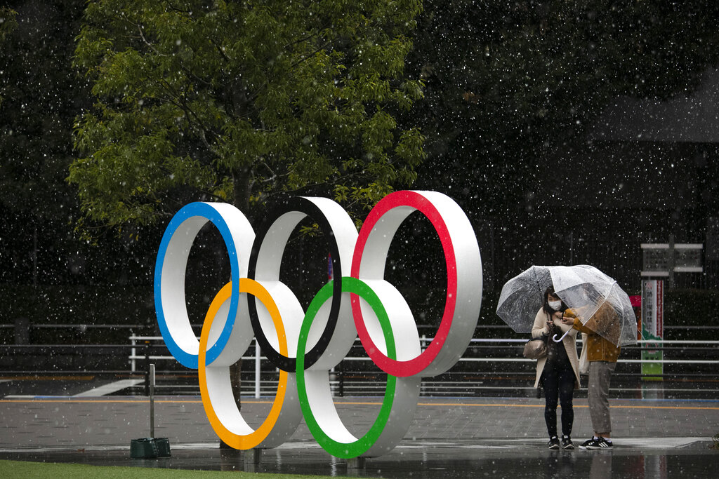 Snow falls on the Olympic Rings near the New National Stadium in Tokyo, Saturday, March 14, 2020

