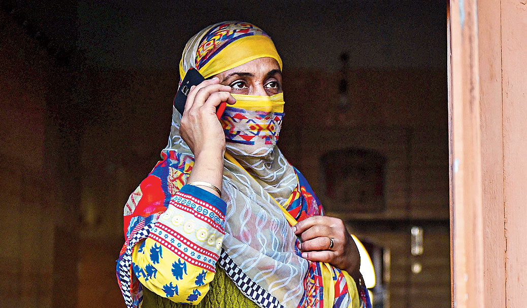 A woman talks to her son in Srinagar on Monday. 