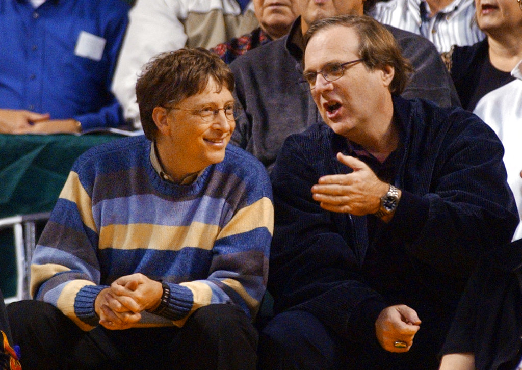 In this March 11, 2003, photo, Bill Gates chats with Paul Allen during a game between the Trail Blazers and Seattle SuperSonics in Seattle.