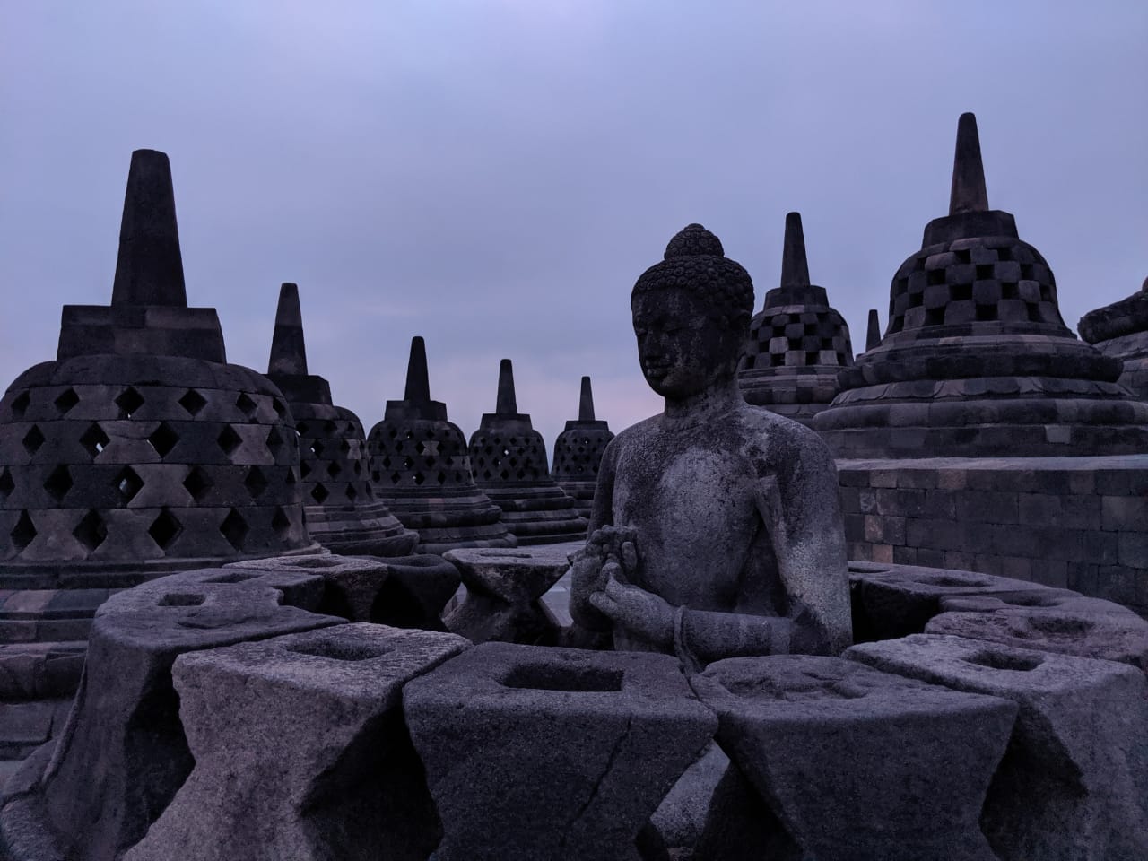 At sunrise the Borbadur temple is a majestic sight to behold as the meditative Buddhas and stupas in and around the temple complex slowly take shape with the breaking dawn