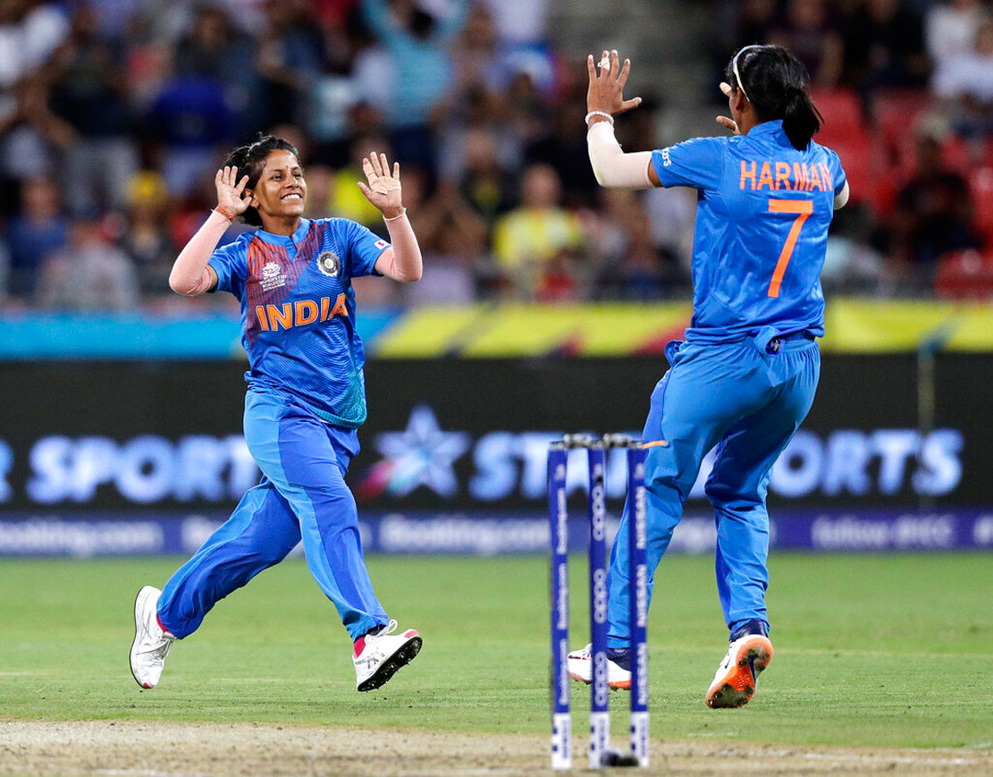 Poonam Yadav (left) celebrates with teammate Harmanpreet Kaur after taking the wicket of Australia's Jess Jonassen during the first game of the Women's T20 Cricket World Cup in Sydney on Friday