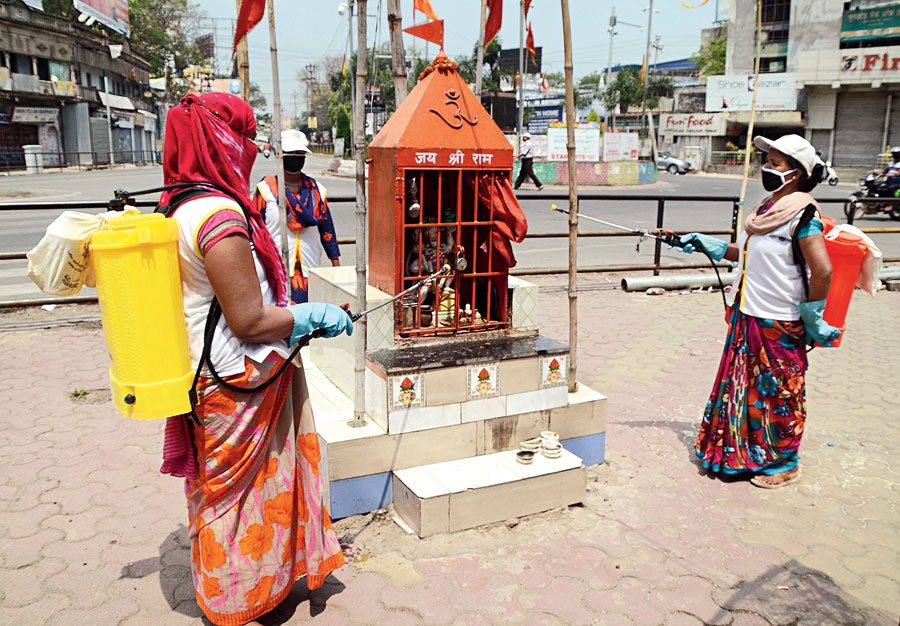 RMC workers sanitise a temple at Albert Ekka Chowk on Sunday