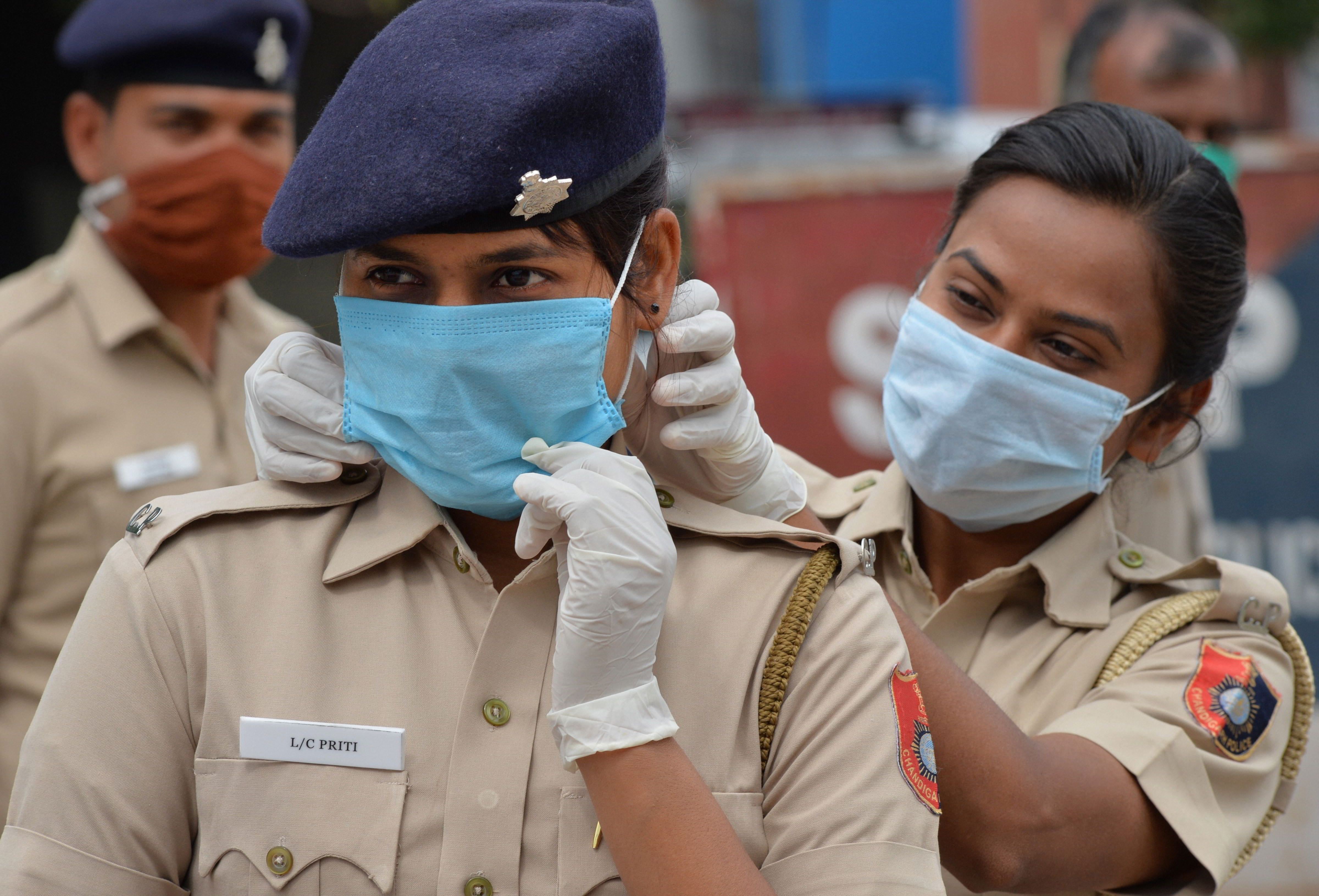 Police personnel wear face masks during a nationwide lockdown in the wake of coronavirus pandemic, in Chandigarh, Friday, April 10, 2020