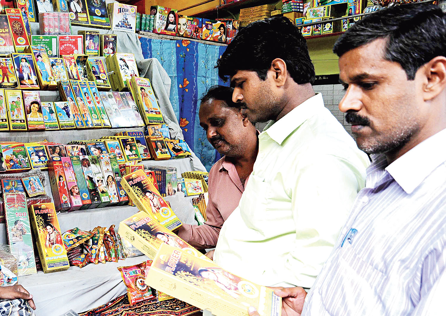 Customers purchase crackers at Khajekalan in Patna City on Sunday. 
