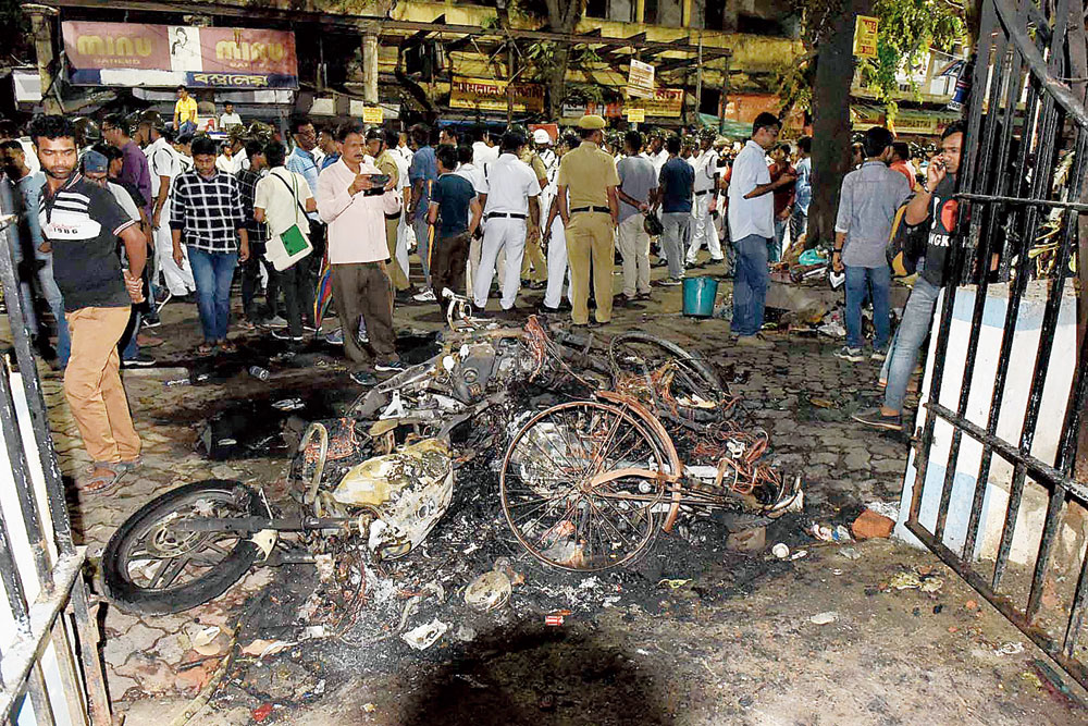 The charred remains of motorcycles in front of Vidyasagar College on Tuesday evening.