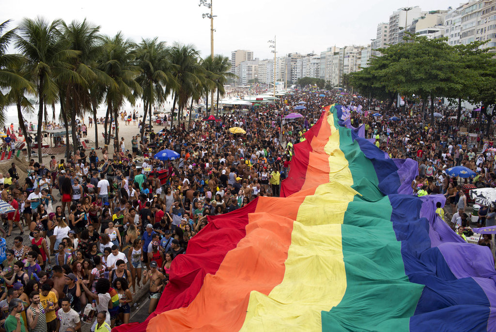 A giant gay pride flag made its way through the Copacabana beach.