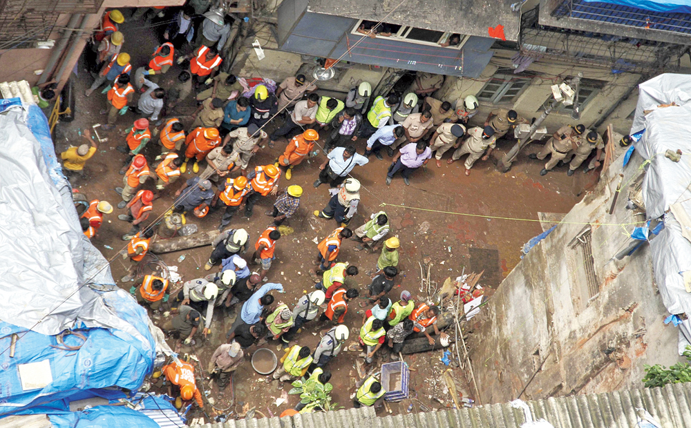 Rescuers conduct search operation at the site of the collapsed  building at Dongri in Mumbai on Wednesday