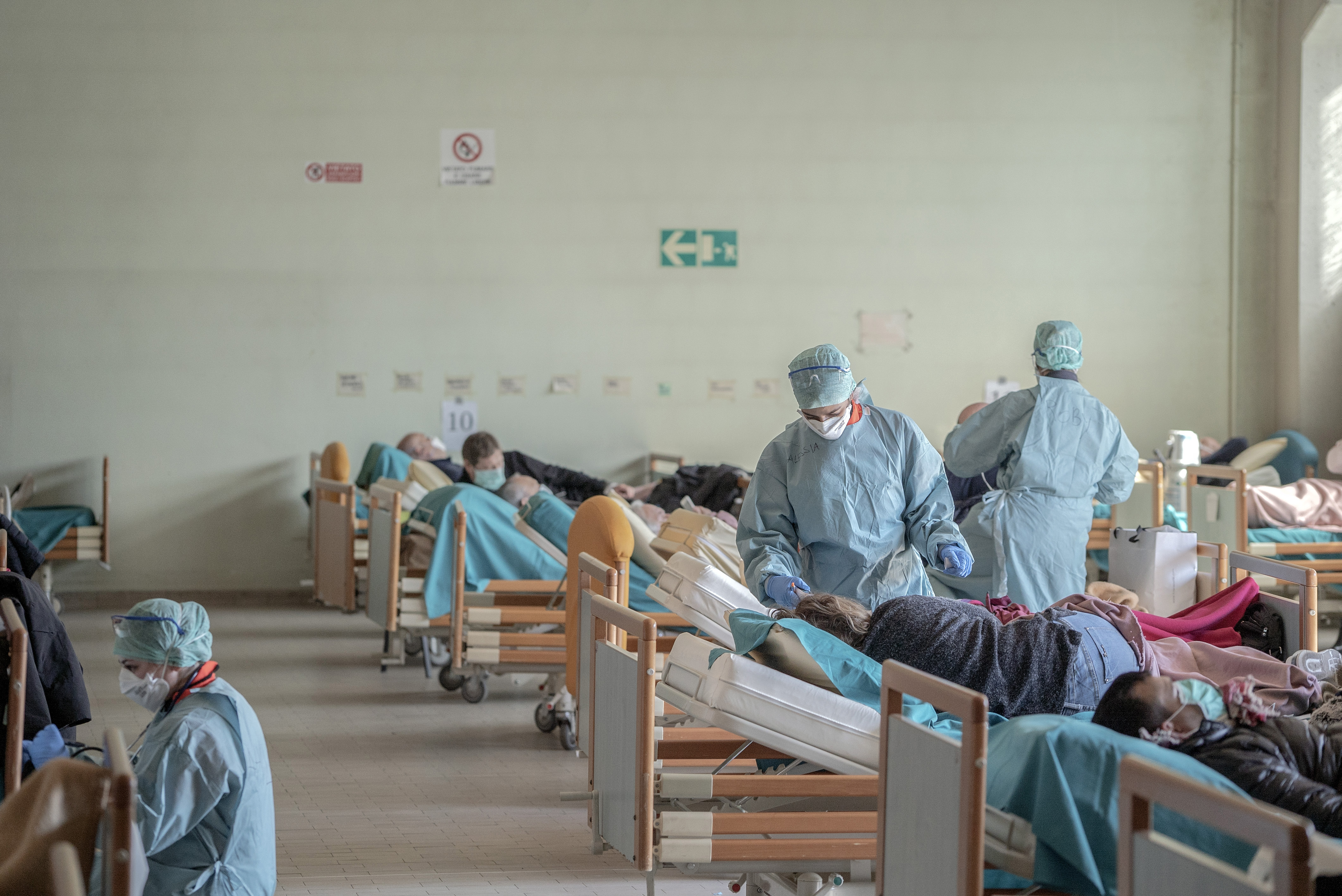 The laundry area of a hospital in Brescia, Italy, has been filled with beds for patients awaiting who are being tested for the coronavirus, Monday, March 16, 2020.
