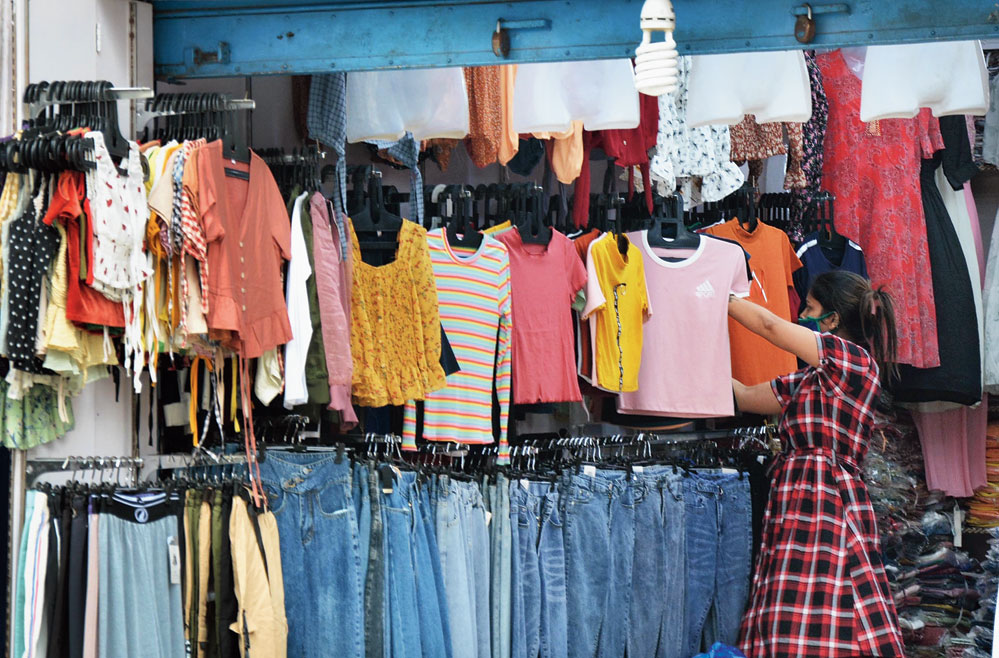 A customer checks out clothes at a shop at Fancy Bazar in Guwahati on Tuesday. 
