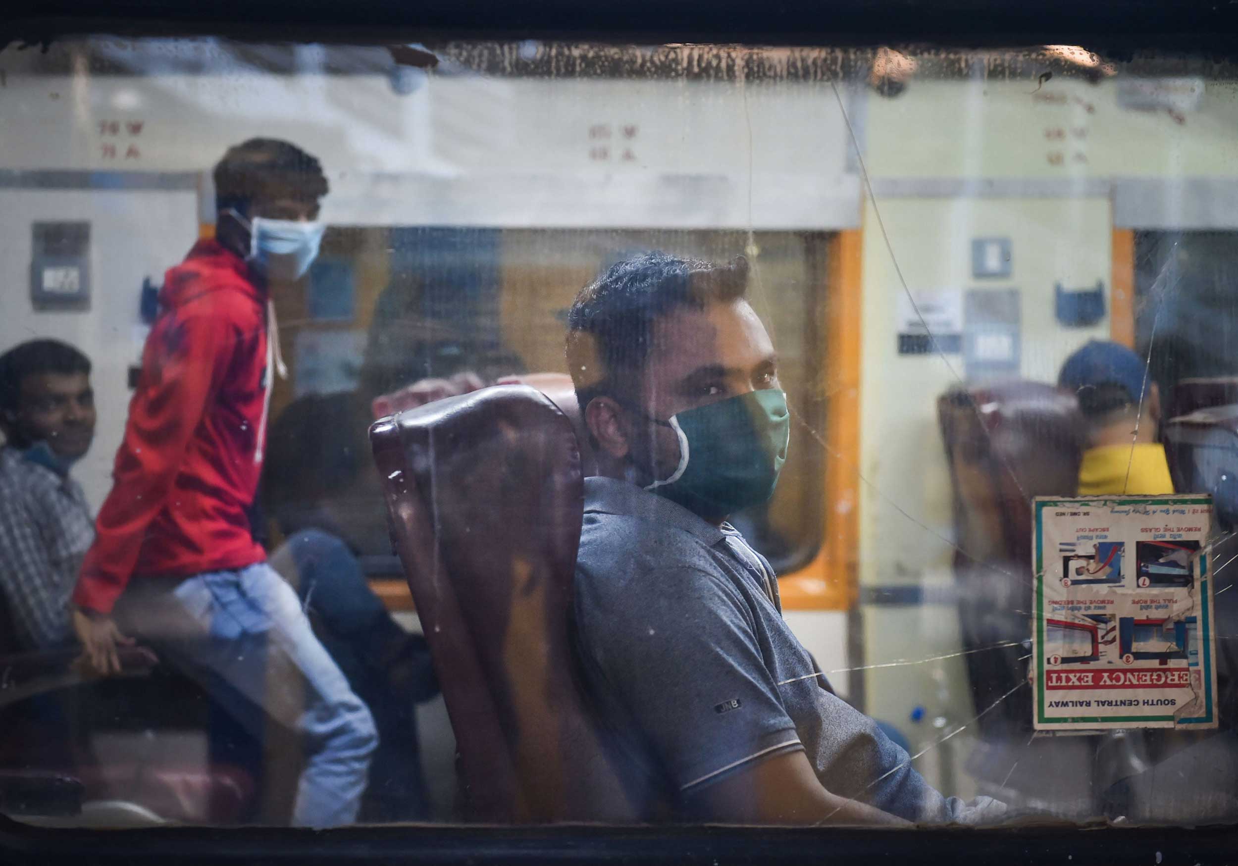Passengers wear masks as a precautionary measure against coronavirus at Chhatrapati Shivaji Maharaj Terminus in Mumbai on Tuesday.