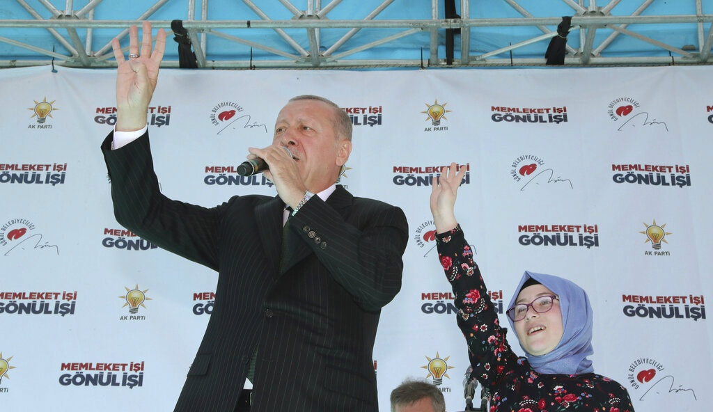 Turkey's President Recep Tayyip Erdogan witzh a young supporter at a rally in Eregli, Turkey, on Tuesday.