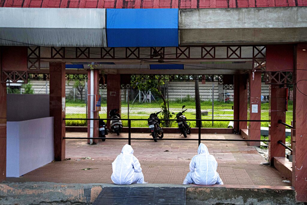 Health workers wearing personnel protection equipments (PPE) take rest in Guwahati Medical College Hospital (GMCH) in Guwahati, Sunday, May 17, 2020.